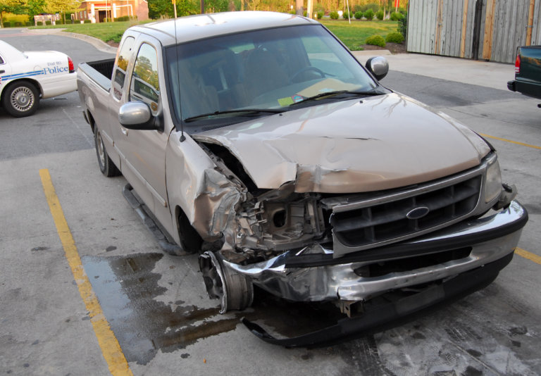 Truck with a large dent near the front right headlight