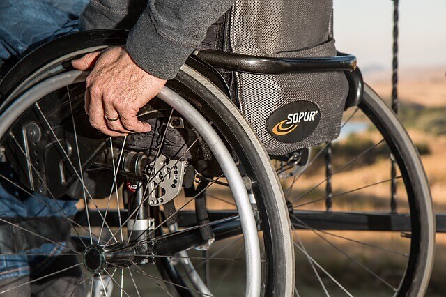 man with paralysis on wheelchair