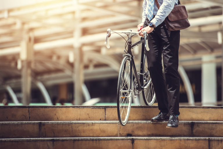 A cyclist leaving work on his bike.