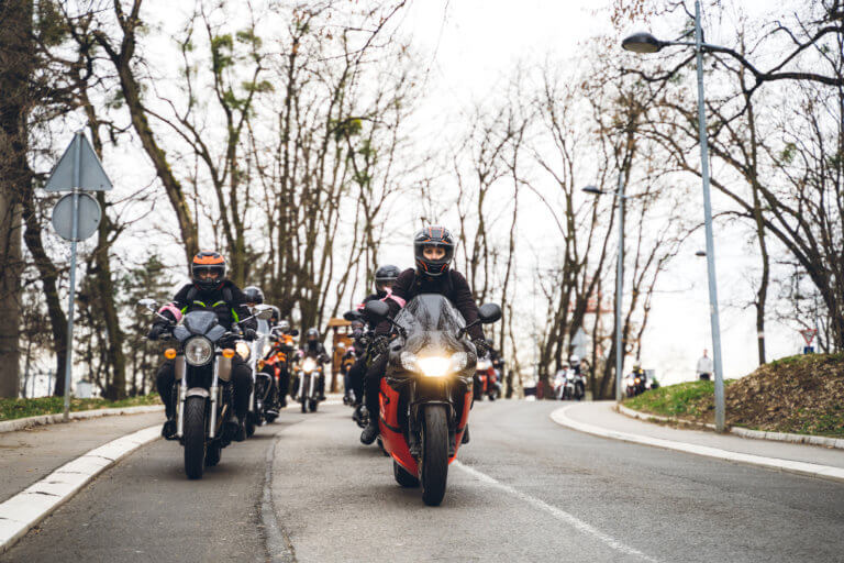 Motorcycles that are lane-splitting on a highway.