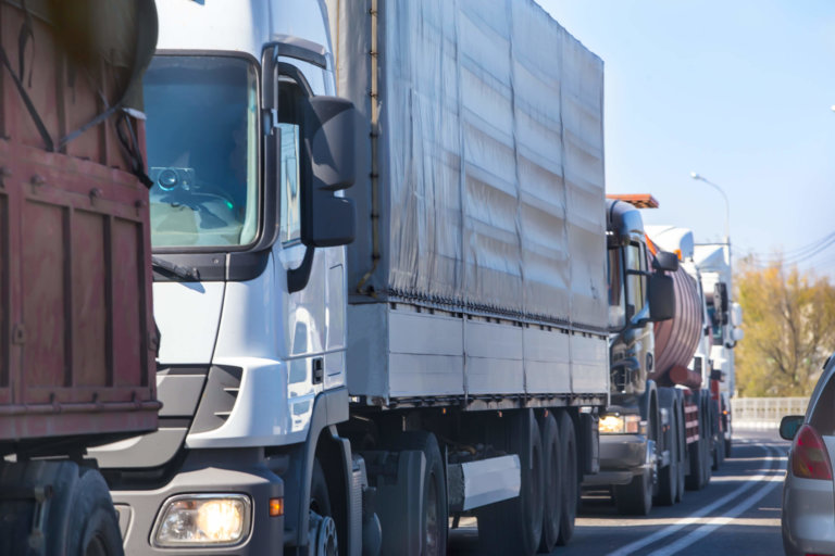 Line of trucks driving down the road.