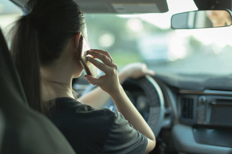 Teen driving and on the phone.