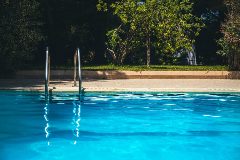 Empty swimming pool in a backyard.