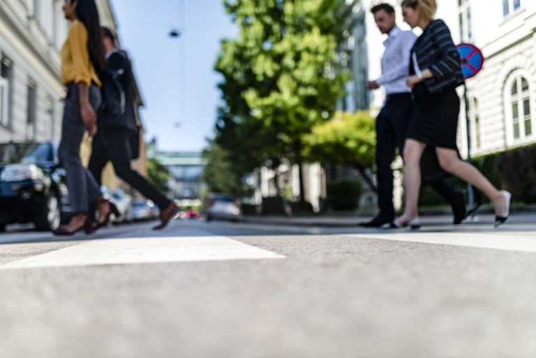 pedestrians walking across crosswalk