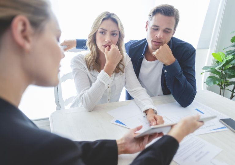 couple discussing personal injury lawsuit with attorney