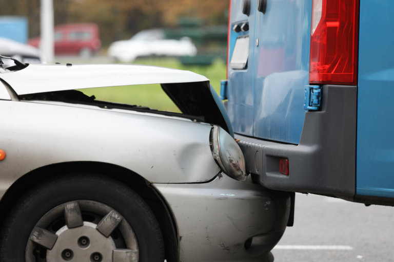 car crashed under van