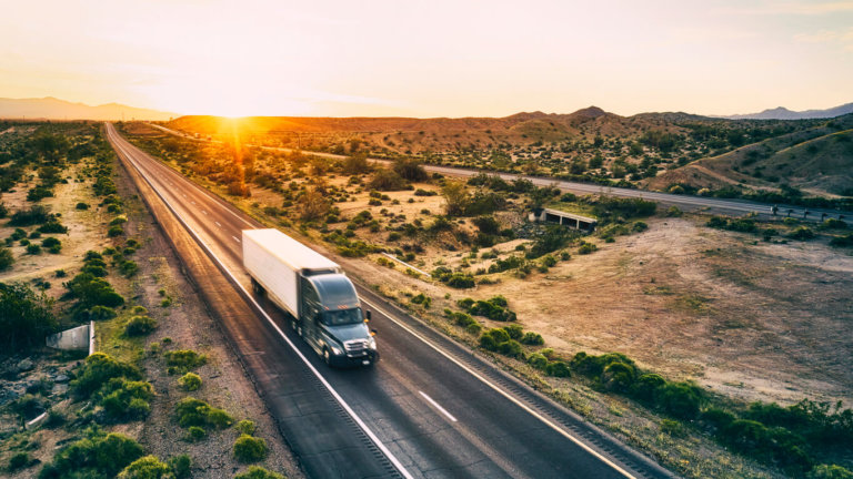 truck driving down an empty road