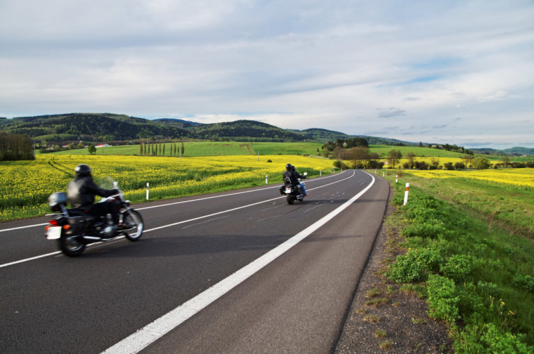 motorcycles driving down the road