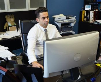 Yosi working at his desk on a computer