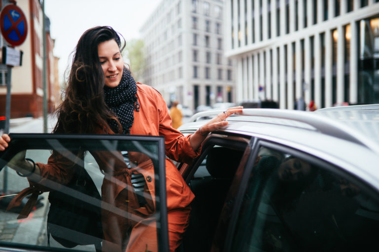 rideshare passenger getting in car