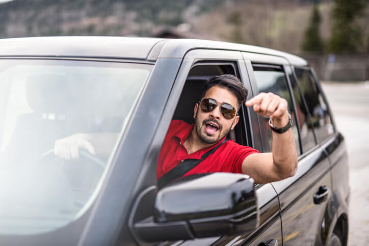 angry man yelling at car in front of him