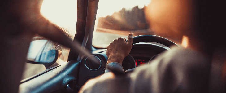 persons hand on the steering wheel improper turning