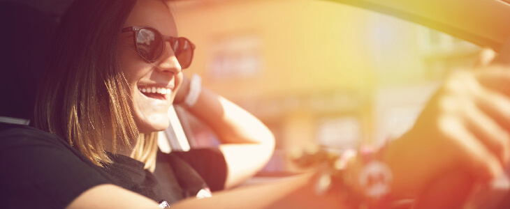 woman with sunglasses smiling while driving types of car accidents