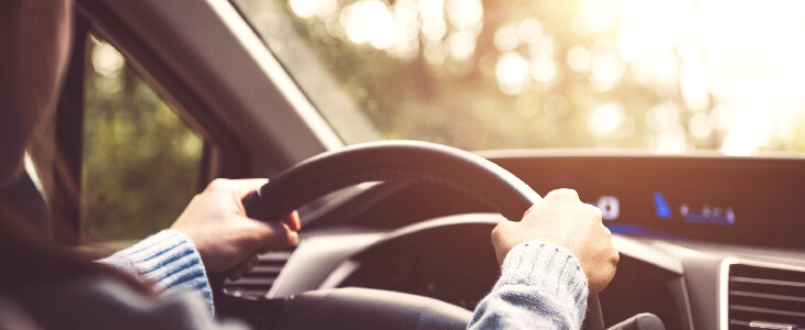 woman with both hands on the steering wheel wrongful death from a car accident