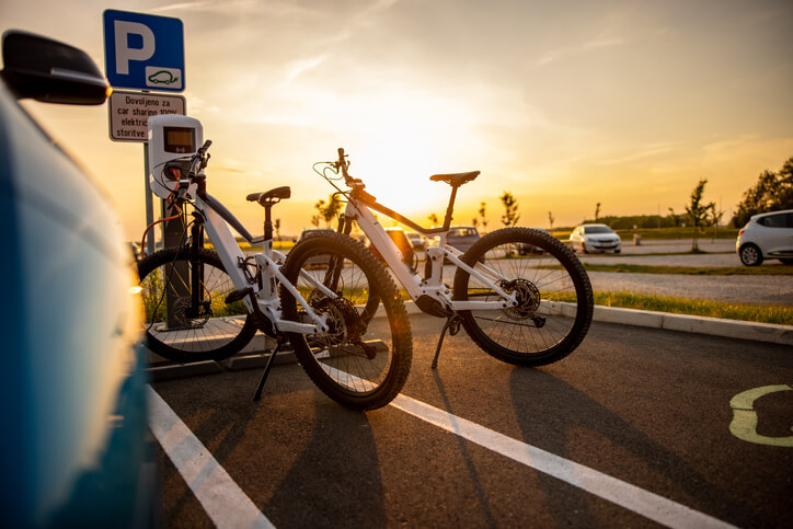 Two electric bicycles being charged at the electric vehicle charging station