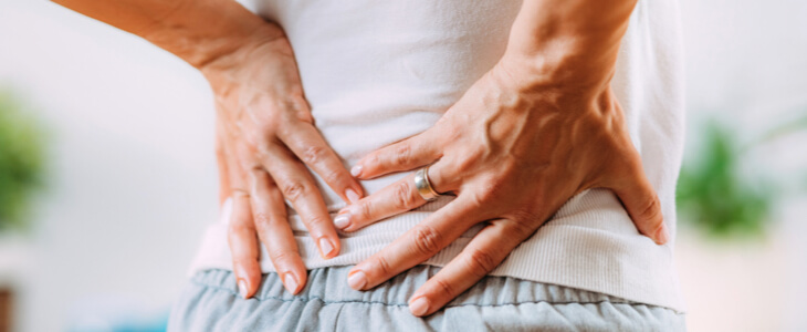 Man holding lower back in pain from an injury