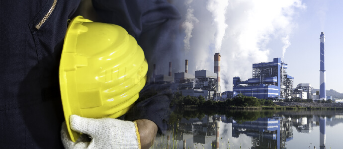 Mechanic engineer wearing cloth gloves, holding a safety helmet (hard hat) with Lignite or Coal power plants, toxic exposure