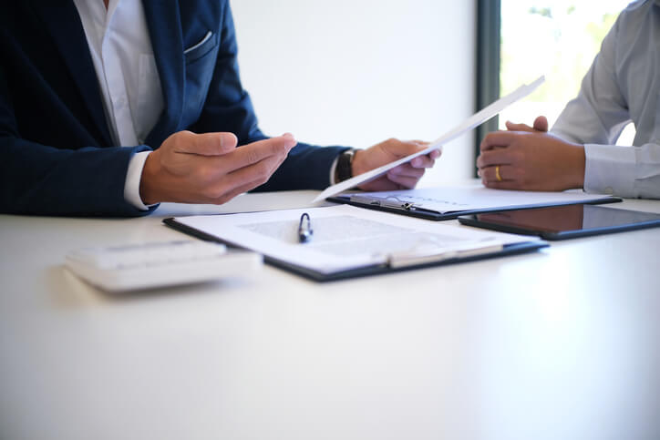 Wrongful death attorney sitting with client