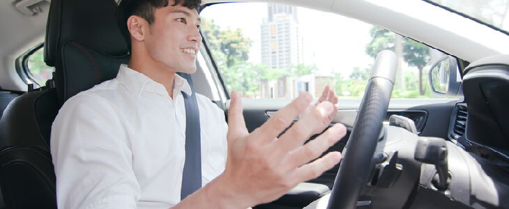 asian man sitting in self-driving car