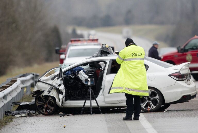 Police officer investigating car crash