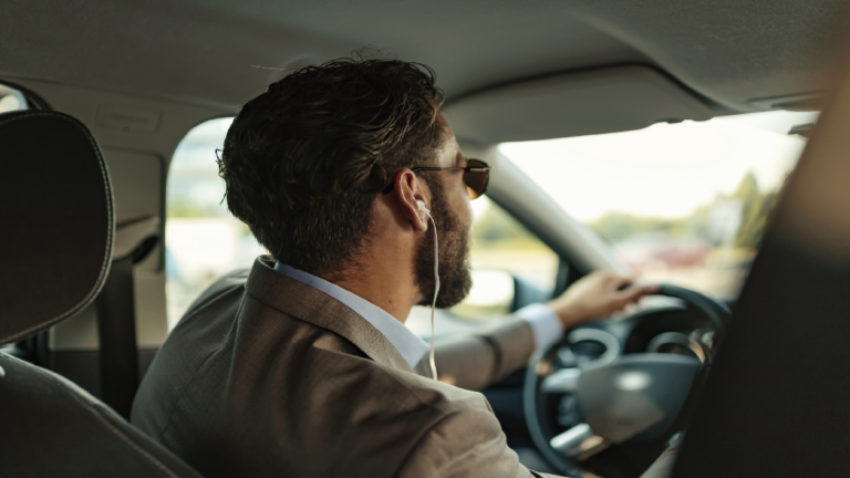 man driving with headphones