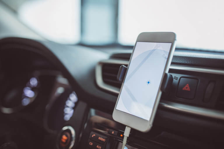 Smartphone held up in car for navigation.