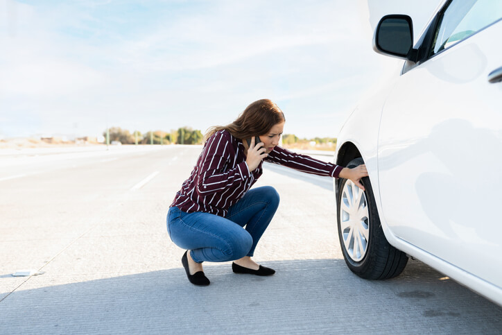 woman dealing with tire issues
