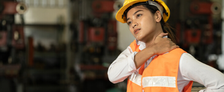 Worker clutching neck and back in pain after an injury