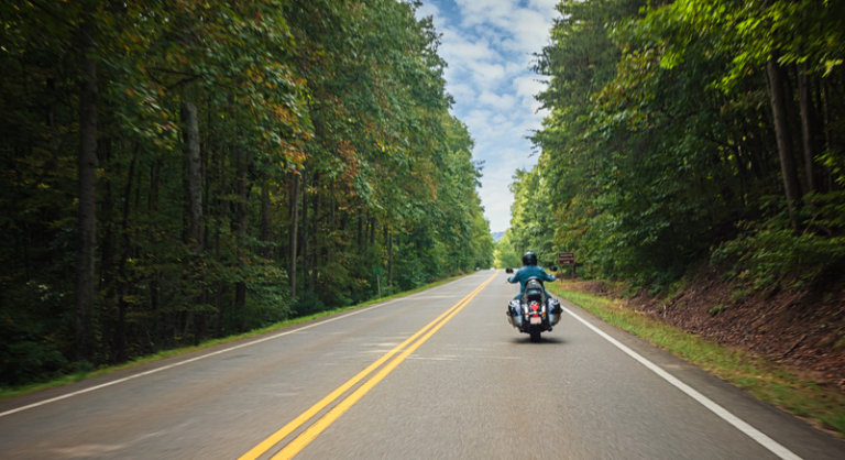 motorcycle riding along road