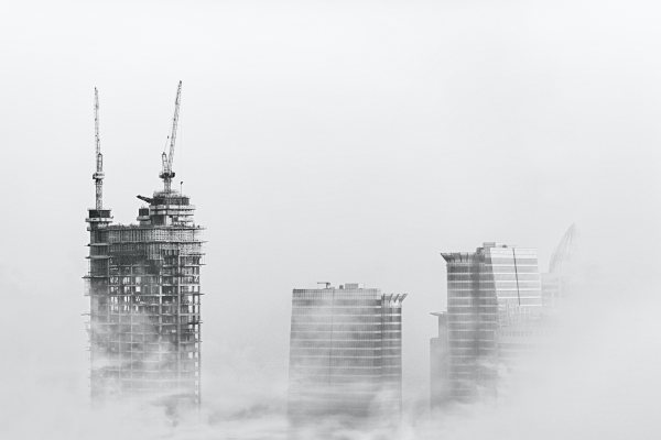 high-rise buildings under construction in heavy fog