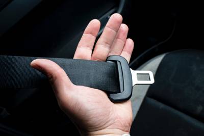 a person holding a car seat belt