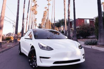 Weißes Elektrofahrzeug auf einer kalifornischen Straße