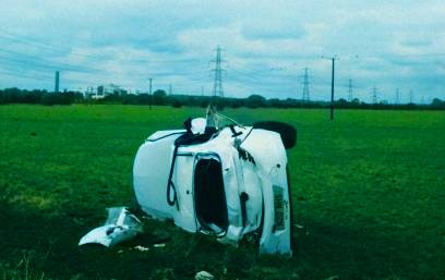 rolled over car in a field after a car accident