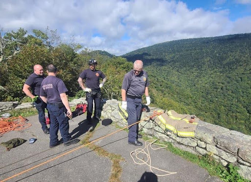 firefighters looking down a cliff