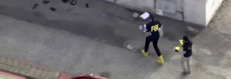 two fbi agents at the scene of a blast that injured 16 SWAT members
