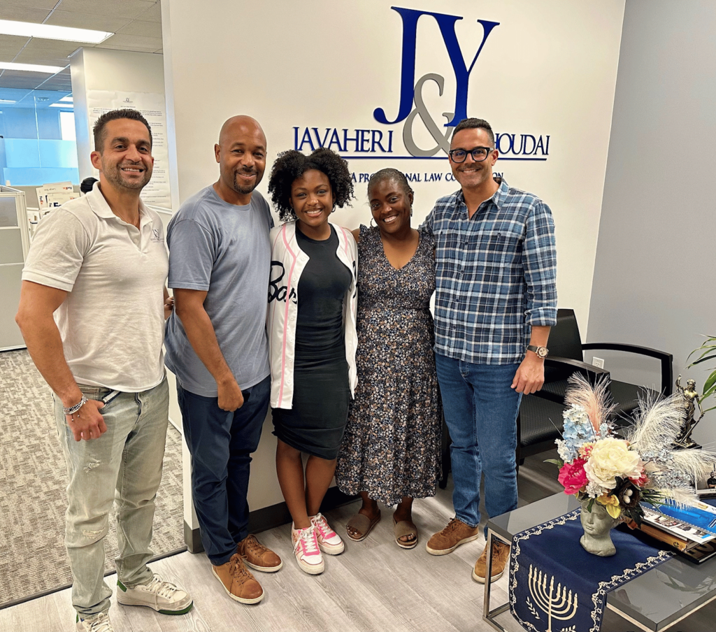 A group photo of J&Y Law Scholarship Winner Moriah Mosley with her parents and attoreys Jason Javaheri and Yosi Yahoudai in their office.