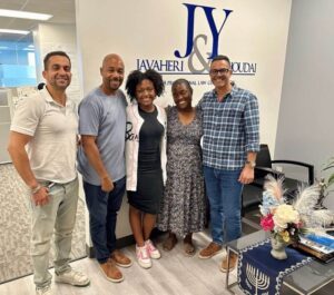 A group photo of J&Y Law Scholarship Winner Moriah Mosley with her parents and attoreys Jason Javaheri and Yosi Yahoudai in their office.