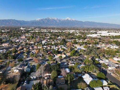 Aerial,View,Of,Ontario,City,In,California,With,Mountains,In