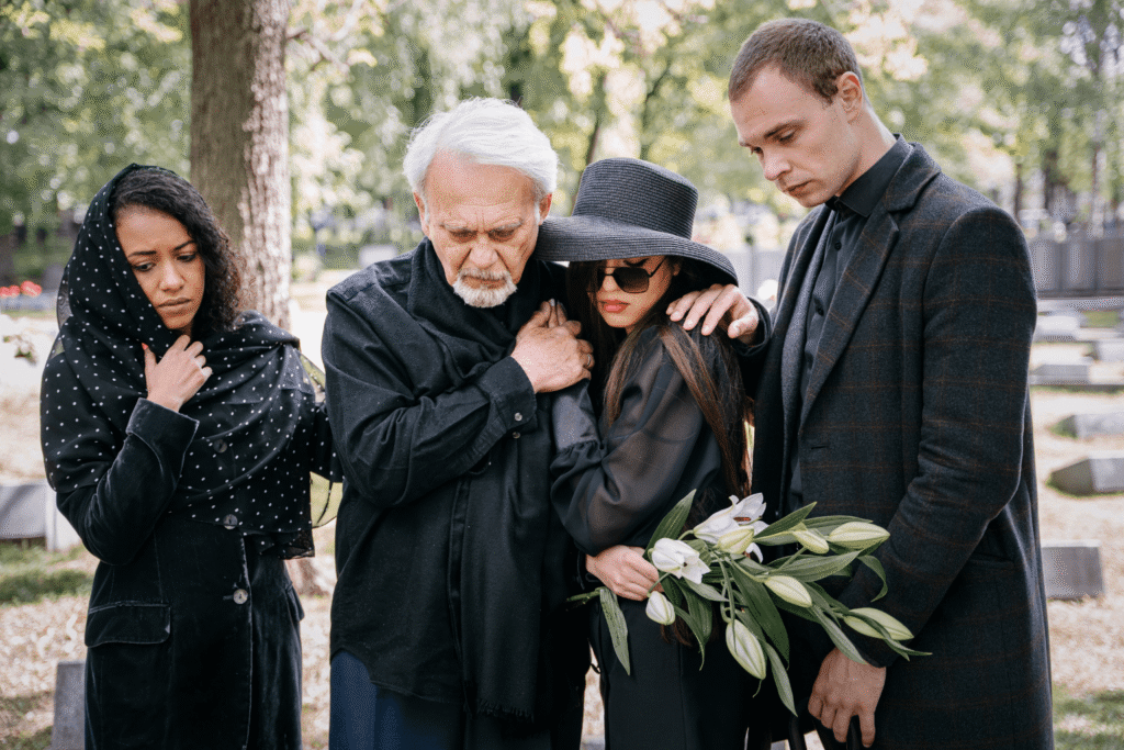 A family grieving at a funeral for a wrongful death.